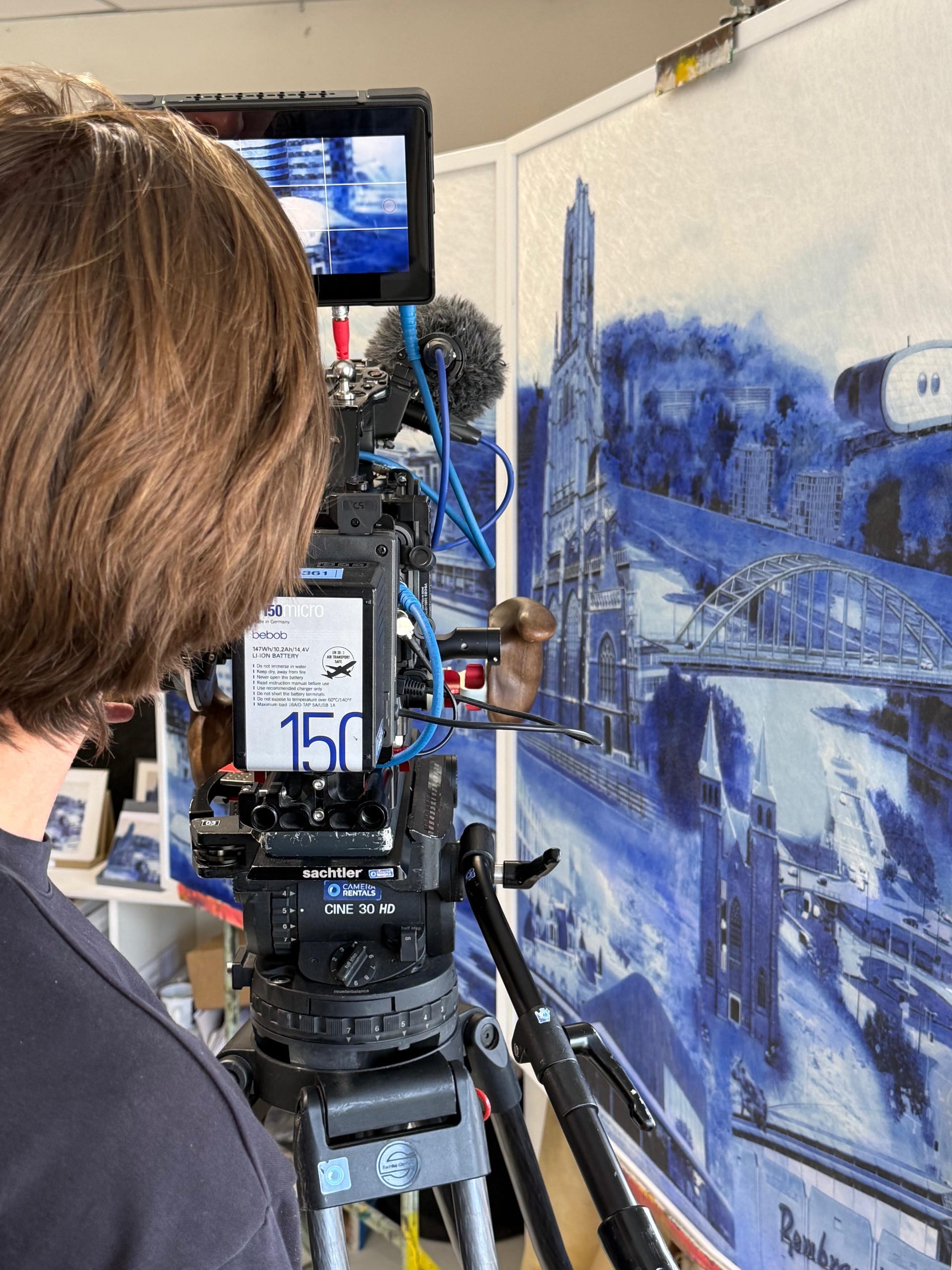 Filming in the studio, beside a work from the series