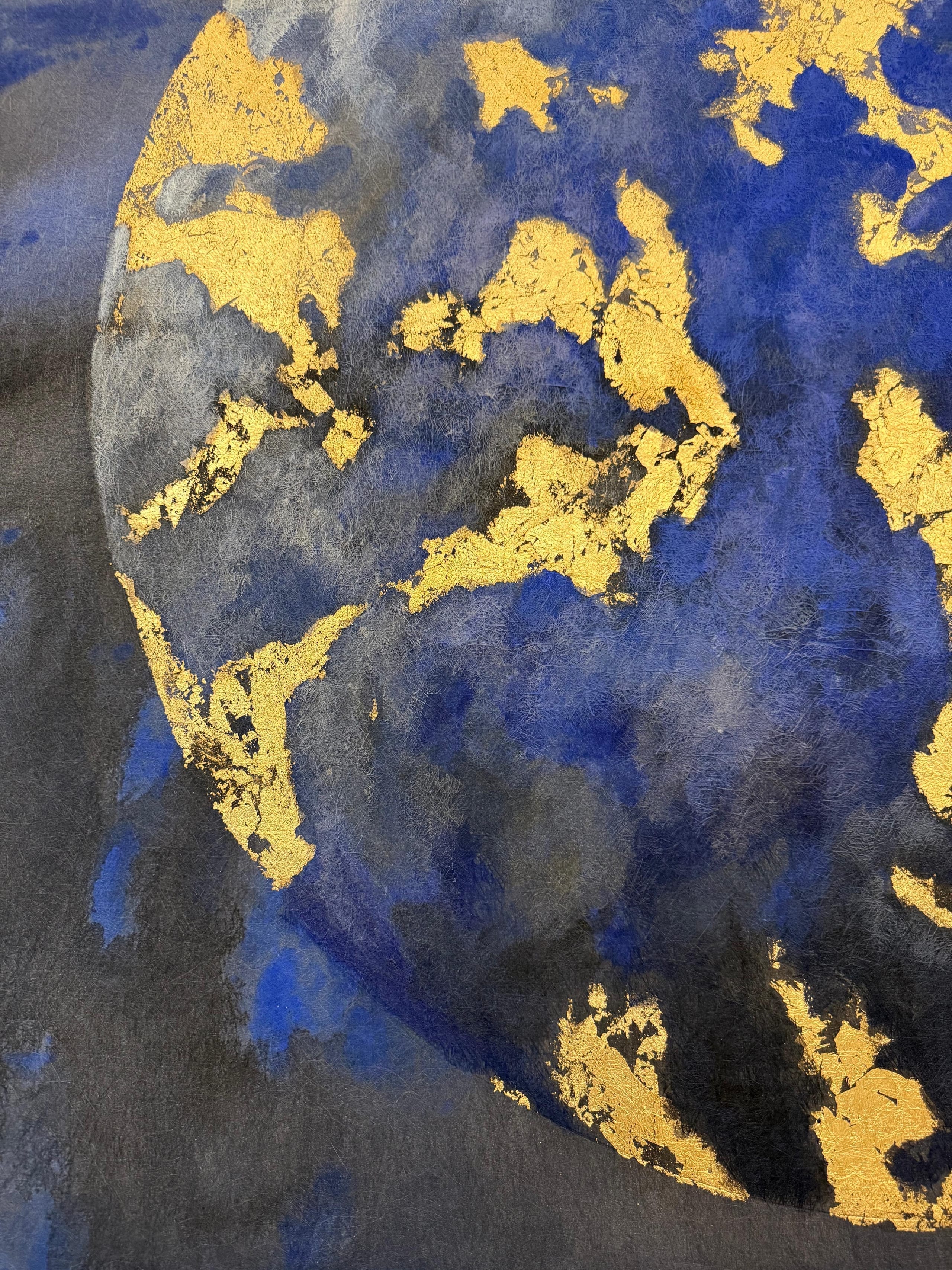 Detail of a planet in acrylic and gold-coloured metal leaf